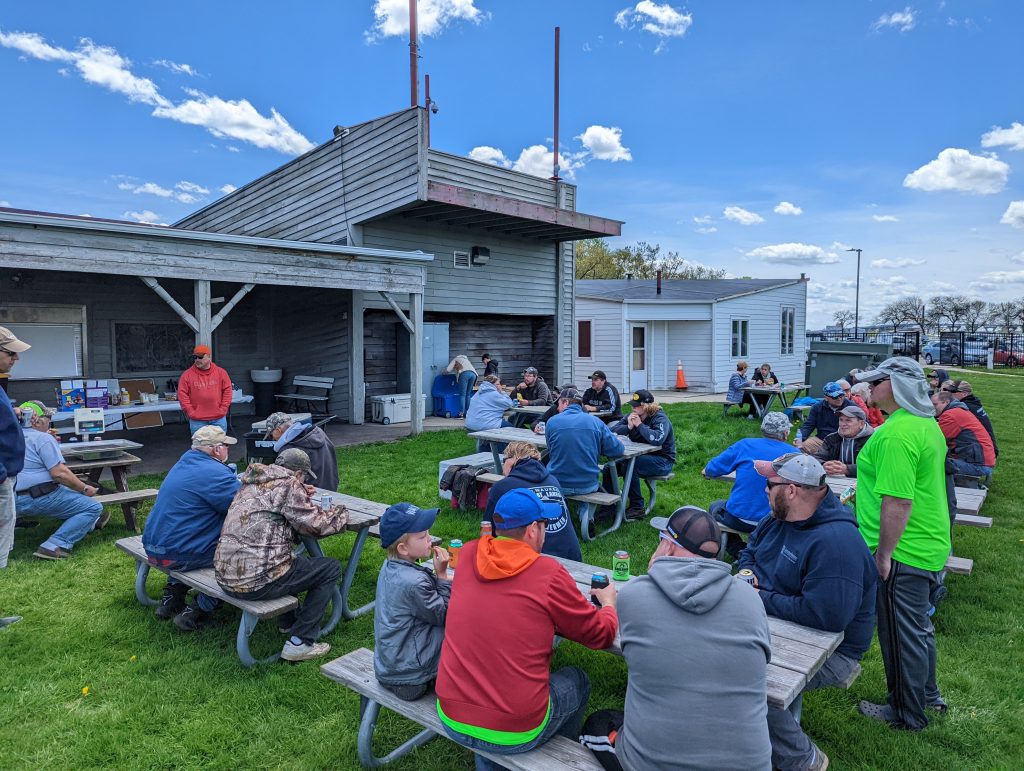 Club members sharing lunch on the lawn at McKinley Marina after a fish-in